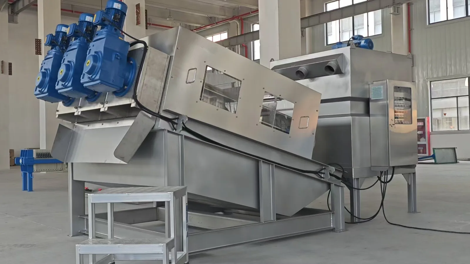 Three-shaft screw press with control cabinet and discharge chutes